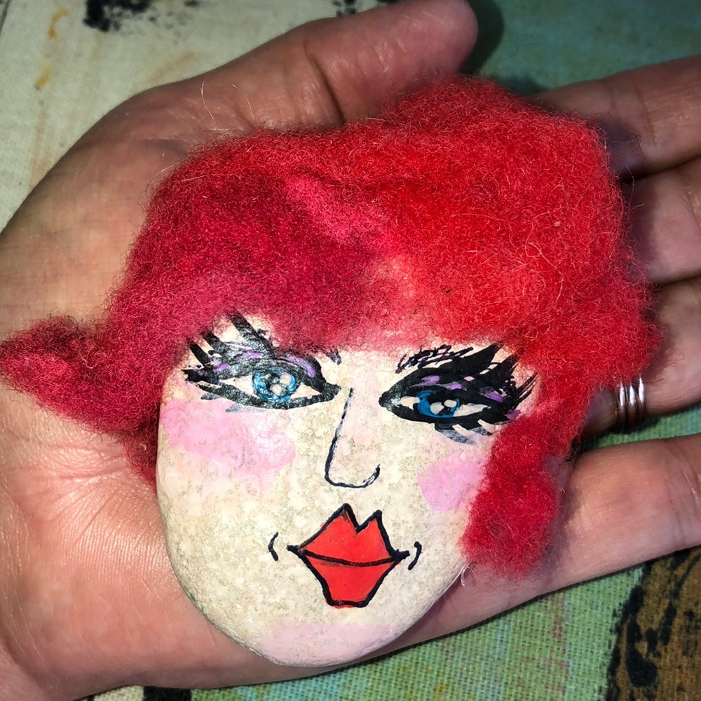 Rock painted face, big lips, wool pink red hair.
